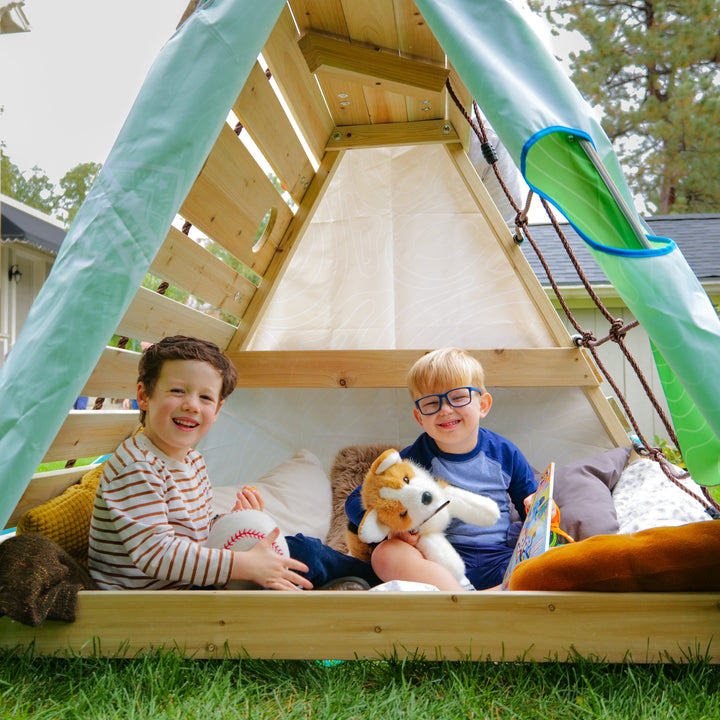 Kids playing in the Little Cabin playhouse